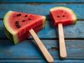 Watermelon slice popsicles on a blue rustic wood background Royalty Free Stock Photo