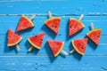 Watermelon slice popsicles on a blue rustic wood background, Pop Royalty Free Stock Photo