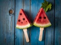 Watermelon slice popsicles on a blue rustic wood background Royalty Free Stock Photo