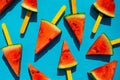 Watermelon slice popsicles on blue wood background. Royalty Free Stock Photo