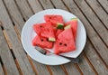 Watermelon slice on white plate on wooden background Royalty Free Stock Photo