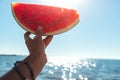 Watermelon slice in woman hand over sea Royalty Free Stock Photo