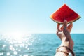 Watermelon slice in woman hand over sea Royalty Free Stock Photo