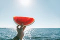 Watermelon slice in woman hand over sea Royalty Free Stock Photo