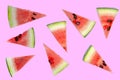 Watermelon slices cut into triangles. Pink background.