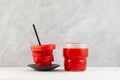 Watermelon slices with drinking straw, and glass of juice. Concept of refreshing cocktails and smoothies made from fresh Royalty Free Stock Photo