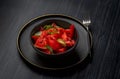 Fresh watermelon salad kept in a black bowl and plate on dark background Royalty Free Stock Photo