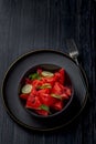 Fresh watermelon salad kept in a black bowl and plate on dark background Royalty Free Stock Photo