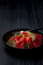 Fresh watermelon salad kept in a black plate on dark background Royalty Free Stock Photo