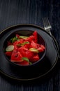 Fresh watermelon salad kept in a black bowl and plate on dark background Royalty Free Stock Photo