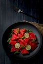 Fresh watermelon salad kept in a black plate on dark background Royalty Free Stock Photo