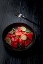 Fresh watermelon salad kept in a black plate on dark background Royalty Free Stock Photo