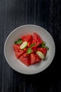 Fresh watermelon salad kept in a white bowl on dark background Royalty Free Stock Photo