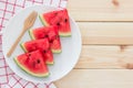 Watermelon slices on the white porcelain plate over wooden background Royalty Free Stock Photo