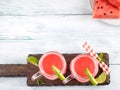 Watermelon smoothie with lime and mint in mason jar on white wooden background. Overhead shot Royalty Free Stock Photo