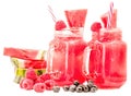 Watermelon smoothie in a mason jar decorated with a slice of watermelon, raspberries, blueberries and ice cubes isolated on white Royalty Free Stock Photo