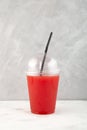 Watermelon smoothie with melon juice in disposable plastic take away cup. Street food Royalty Free Stock Photo