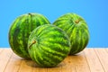 Watermelons 3d rendering with realistic texture on the wooden table