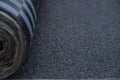 Waterproof bitumen roll covered with insulation materials, abstract background, closeup texture. Royalty Free Stock Photo