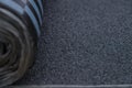 Waterproof bitumen roll covered with insulation materials, abstract background, closeup texture. Royalty Free Stock Photo