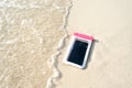Waterproof case on a smartphone, phone for taking pictures under water. Phone in the waterproof case underwater, on the sands