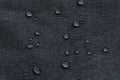 Waterproof droplets on fabric. Black Canvas Polyester texture synthetical for background. Black polyester textile backdrop for Royalty Free Stock Photo