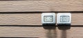 Waterproof electrical sockets installed outdoors on dark wooden walls Royalty Free Stock Photo