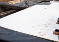 Waterproof membrane and underfloor insulation, to reduce heat loss in the future, is being placed by construction workers