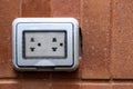 The waterproof of power socket on the outside brick wall of building for protect electronic plug from water