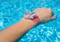 Waterproof watch on wrist in a swimming pool