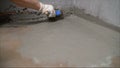 Waterproofing coating. Cover the concrete wall with a cement-polymer waterproofing membrane. Worker waterproofing with a brush