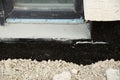 Waterproofing house foundation with spray on tar and roll waterproofing Royalty Free Stock Photo