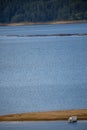 Waters of the lake, sand and lonely fishing boat Royalty Free Stock Photo