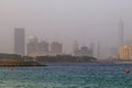 The waters of the Persian Gulf and the skyscrapers of Dubai in the distance during a summer sunrise sunset on the Palm Jumeirah. Royalty Free Stock Photo