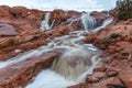 the waters of red rock stream on a rocky mountain side Royalty Free Stock Photo