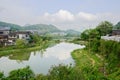 Waterside tile-roofed buildings across from walled Qingyan town