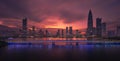 Waterside view of a bridge before the buildings of Shenzhen under the red sunset sky