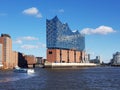 Waterside view of the Elbphilharmonie Hamburg concert hall building before the blue skyline