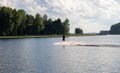 Waterskier silhouette moving fast in splashes of water at sunset