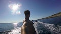 Waterskiing on surfboard behind a rubber boat slowmotion