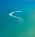 Watersports at the beach. Speedboat and wave slider leaving zigzag trail on water, aerial view Royalty Free Stock Photo