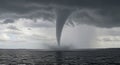 Waterspout Touching Down on Ocean Under Dramatic Dark Sky Royalty Free Stock Photo