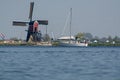 Waterways of North Holland and view on traditional Dutch wind mill, spring landscape