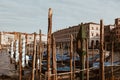 Waterways in venice at sunset with parked gondola - tourism attraction