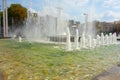 Waterworks fountain with water sprays and geysers on city park or street. Autumn day time freshness and relax concept. Clear aqua