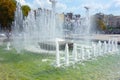 Waterworks fountain with water sprays and geysers on city park or street. Autumn day time freshness and relax concept. Clear aqua Royalty Free Stock Photo
