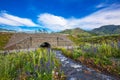 Waterworks laid under the road. Gorny Altai, Russia Royalty Free Stock Photo