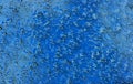 Watery textured background of water drops on glass with blue sky through Royalty Free Stock Photo