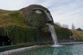 Wattens, Austria - March 18, 2023 - a fountain with giant head spitting water into a pond at Swarovski Kristallwelten