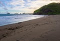 watu ulo beach coast, reef island, and hill Royalty Free Stock Photo